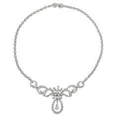 This exquisite estate necklace from the Art Nouveau era, weighing 31.93 grams, is crafted in platinum and features an elegant drop design. The necklace showcases a total of 6.00 carats of diamonds, including round and pear cut stones with G-J color and VS/SI clarity. This luxurious piece embodies the graceful and artistic style of the Art Nouveau period, making it a timeless addition to any jewelry collection. Classic Pear-shaped Bridal Necklace With 17 Jewels, Formal Silver Pear-shaped Diamond Necklace, Platinum Necklaces With Diamond Accents, Pear-shaped, Elegant Pear-shaped Diamond Drop Necklace, Silver Platinum Pear-shaped Necklace, Pear-shaped Platinum Silver Necklace, Exquisite Pear-shaped Diamond Necklace For Formal Events, Exquisite Pear-shaped Diamond Necklace For Formal Occasions, Elegant Briolette Diamond Necklace For Formal Occasions