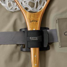 a close up of a tennis racquet on a bed with the strings attached to it