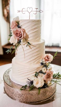 a white wedding cake sitting on top of a table