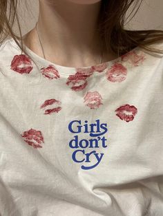 a girl with lipstick on her shirt that says girls don't cry