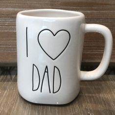 a white coffee mug with the words i love dad written in black ink on it