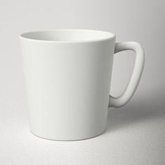 a white coffee cup sitting on top of a table