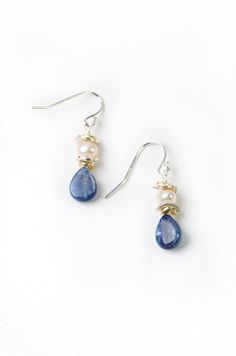 Elegant pearls with rich blue kyanite create both a dressy and laid back pair of handmade dangle silver and pearl earrings for women! Simple pearls with kyanite briolette drop are fun for everyday wear. Sterling silver Freshwater pearl, kyanite Approx 1.5" length Our unique handcrafted designer jewelry for women is made in America, each design created individually in our personal design studio in Floyd VA USA Simple Gemstone Earrings, Blue Teardrop Pearl Drop Earrings, Handmade Drop Earrings, Everyday Jewelry Simple, Diy Earrings Dangle, Floyd Va, Dangle Silver Earrings, Handmade Pearl Jewelry, Dark Blue Earrings