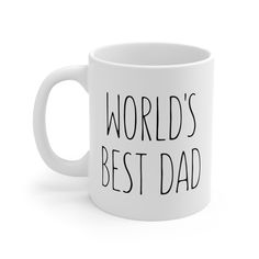 a white coffee mug with the words world's best dad printed on it in black