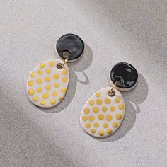 A pair of golden polka dot ceramic stud dangle earrings. You can choose the top part in the colors you want. Colour options: * Golden * Black * White * Dimension, ceramic piece: total length 5 cm, width 2.5 cm * Because all our pieces are handcrafted, there may be minor variations form item to item. * Perfect gift for your girlfriend, wife, friend, mom or valentine. ➡ Visit my shop for more items! https://www.etsy.com/shop/rootandcolor Polka Dot Earrings, Dot Earrings, Gifts For Your Girlfriend, Earrings Dangle, Jewelry Earrings Dangle, Color Options, Polka Dot, Dangle Drop Earrings, Polka Dots