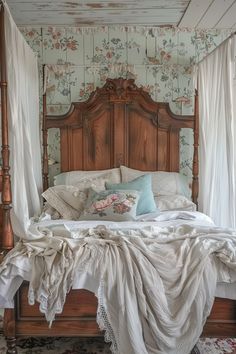 a bed with white sheets and pillows in a bedroom next to a wallpapered wall