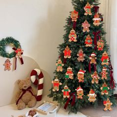 a christmas tree with gingerbread decorations and a teddy bear