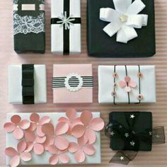 several different types of gift boxes with bows and ribbons on them, all decorated in pink and black