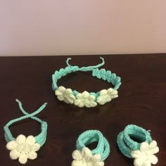 three crocheted bracelets, one with a flower and the other with two rings