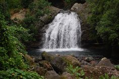 there is a waterfall in the middle of some rocks