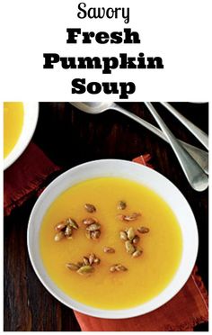 a bowl of fresh pumpkin soup on a wooden table