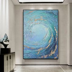 an abstract painting hangs in the middle of a room