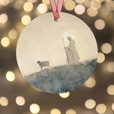 a christmas ornament with a shepherd and sheep