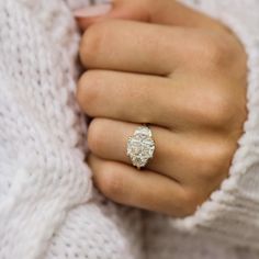 a woman's hand with a ring on it