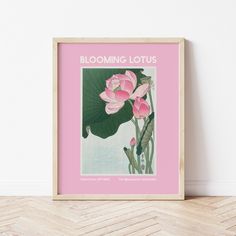 a pink framed poster with water lilies in blooming lotuses on a white wall