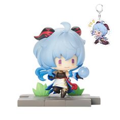 an anime character keychain with a blue hair and black eyes, sitting on top of