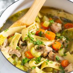 a white bowl filled with chicken noodle soup