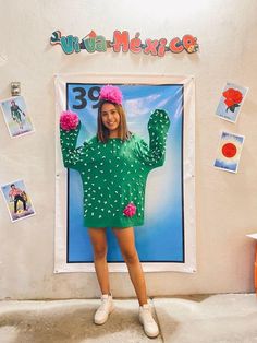 a woman in a cactus costume standing next to a poster with the number 39 on it