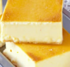 three pieces of cheesecake sitting on top of each other in a metal pan,