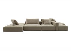 a large sectional sofa with pillows on the bottom and back ends, sitting in front of a white background