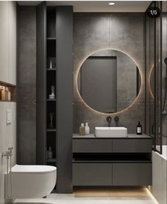 a modern bathroom with a round mirror above the sink