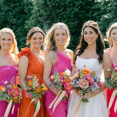 the bridesmaids are all wearing different colored dresses