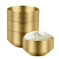 three gold bowls with rice in them on a white background