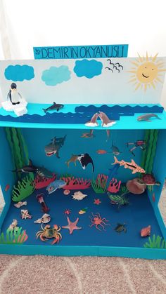 an ocean scene made out of cardboard with paper cut outs and sea animals on it