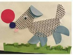 a paper cut out of a dog with a balloon on it's nose and polka dots