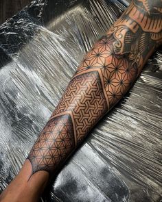 a man's arm with an intricate tattoo design on the forearm and leg,