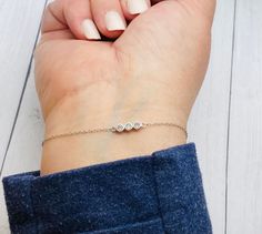 This dainty and beautiful sterling silver bracelet has 3 CZ gemstones and the ashes are secured behind the stones as shown in the photo above.  PLEASE SEND YOUR ASHES WITHIN 2 WEEKS OF PLACING YOUR ORDER. IF I DO NOT RECEIVE THEM IN A TIMELY MANNER YOUR ORDER MAY BE CANCELLED AND YOU MAY NEED TO REORDER. **These are for pet/animal ashes. Etsy's policy does not allow jewelry made with human cremains. If you would like these made with human ashes, please visit my website... Soul-Impressions.com  * Dainty Three-stone Jewelry Gift, Dainty Silver Bracelet With Bezel Setting, Silver Diamond Bracelet With Bezel Setting For Gift, Pet Ashes Jewelry, Cremation Bracelet, Memorial Jewelry Ashes, Cremation Ring, Pet Jewelry, Cremation Necklaces