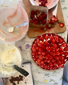 strawberries and other desserts are on the table ready to be cut into pieces