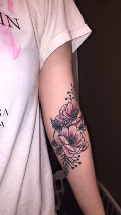 a person with a flower tattoo on their arm