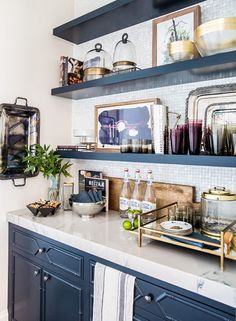 a kitchen with blue cabinets and white counter tops