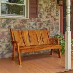 a wooden bench sitting on top of a hard wood porch