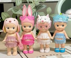 four little dolls are standing next to each other