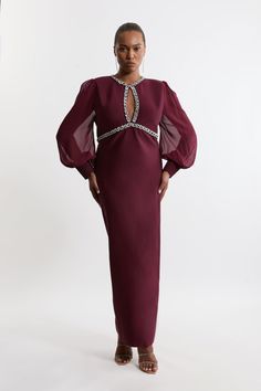 Experience Elevated Occasion Wear In A Plus Size Occasion Dress, Featuring A Fit That Skims The Curves, And Sheer, Chiffon Sleeves With A Balloon Cut For A Playful Edge. The Embellished Trims Make This Piece Perfect For Parties, So Pair It With Strappy Heels For A Look That Takes You To All Upcoming Invites. Plus Size Embellished And Chiffon Sleeve Figure Form Knit Midaxi Dress Statement, Floating Chiffon Sleeves High Neckline Embellished Trim Detailing Figure Hugging Bodice Straight Hanging Ski