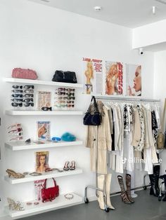 a white closet filled with lots of clothes and shoes next to wall mounted shelving