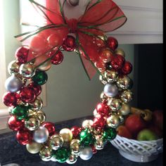 a christmas wreath with red, green and gold ornaments