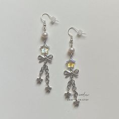 "Handmade Beaded Earrings ✿ Made with glass beads, freshwater pearls, and metal accents ✿ Silver, iridescent clear, and pearlescent white ✿ The earrings are 3.1\"  Fish Hook Options ✿ The Titanium fish hook is hypoallergenic and ideal for sensitive skin ✿ The regular fish hook is made of nickel free metal, it is not hypoallergenic" Silver Pearl Beaded Earrings For Party, White Metal Dangle Crystal Earrings, Handmade Silver Pearl Beaded Earrings, Silver Pearl Beaded Drop Earrings, Diy Earrings Dangle, Kpop Earrings, Ethereal Jewelry, Diy Beaded Rings, Handmade Beaded Earrings