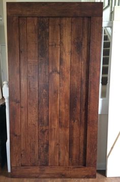 a large wooden door in the middle of a room