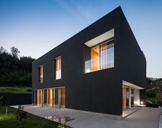 a black house with lots of windows on the side