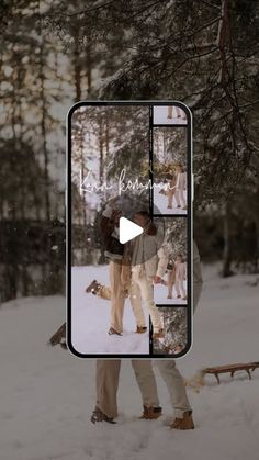 two people standing in the snow with an open cell phone showing them as they are kissing