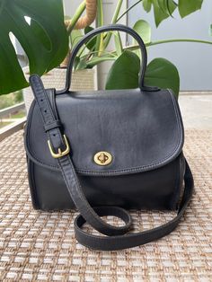 "Style: Vintage Coach Manor Bag Color: Black Leather with Brass Hardware Serial No. G6C-9977 Dimensions: The bag measures 9.5\" wide X 8\" high (not including the top handle) X 5\" deep. The removable crossbody strap is 48\" long, with an adjustable drop of 22\" to 24\"). Condition: The condition of this bag is EXCELLENT. There are some slight indentions in the leather, as you would expect for a vintage bag. You can see these in the photos.  Description: Crossbody or shoulder bag with top handle and turn lock closure on the flap. Inside is not lined. There are two open pockets inside, as well as a center zippered pocket and a zip pocket on the inside back wall with Coach Creed No. G6C-9977 and crafted in United States. There is also an open slip pocket on back of the bag. Includes matching Vintage Coach Bags Outfits, Vintage Bag Aesthetic, Thrift Wishlist, Coach Saddle Bag, 2024 Style, Convertible Crossbody Bag, Vintage Coach Bags, Bags Aesthetic, Vintage Purses