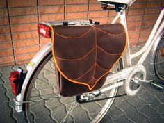 a close up of a bicycle with a bag on the back