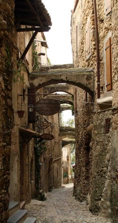 an alley way with stone buildings and stairs