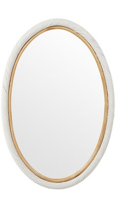 a white and gold circular mirror on a white wall