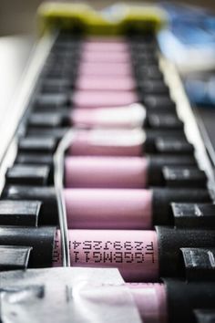 several lipsticks are lined up in rows on the keyboard, and one is pink