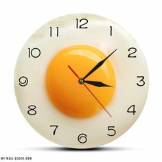 a clock with an egg in the middle of it's face on a white background