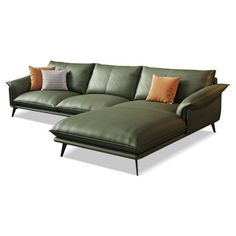 a green leather couch and ottoman with pillows on the bottom half, sitting next to each other